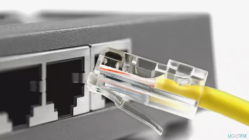 Yellow Ethernet network cable being plugged into the LAN port on the back of a router