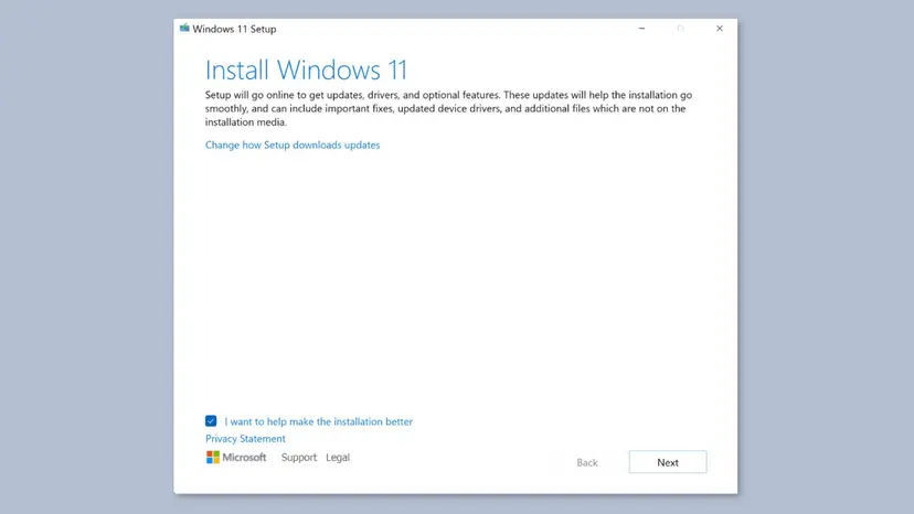Windows 11 Setup window titled Install Windows 11 with the Change how Setup downloads updates link and the Next button